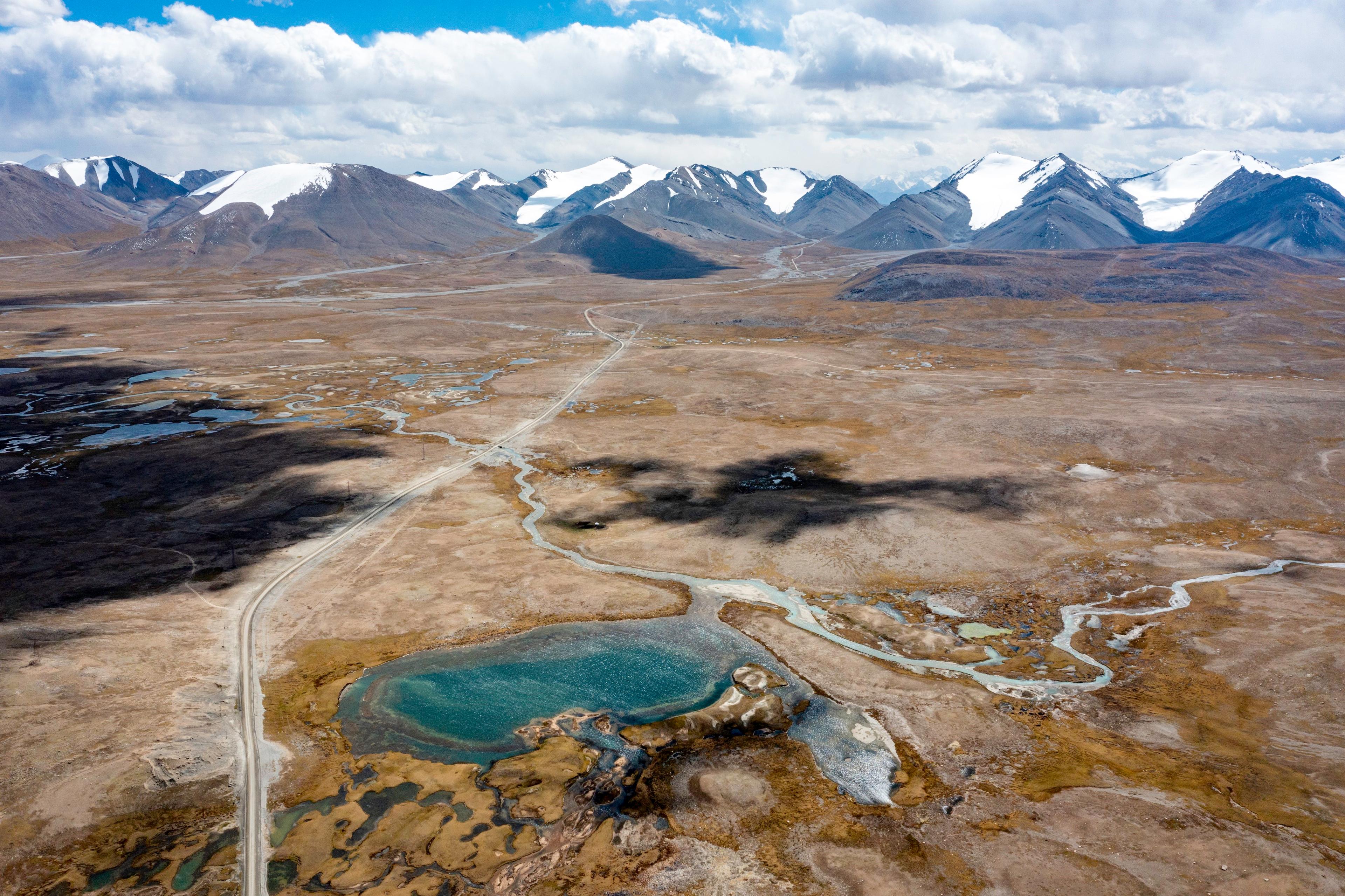 small transparent lakes on the plateau with a wide mountain and small glaciers