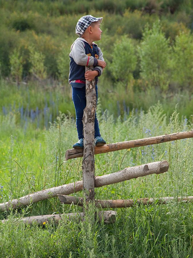 Boy on fence, Barskoon village